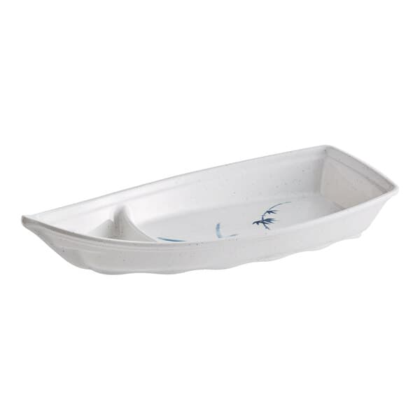 A white boat-shaped dish with a blue design on it.
