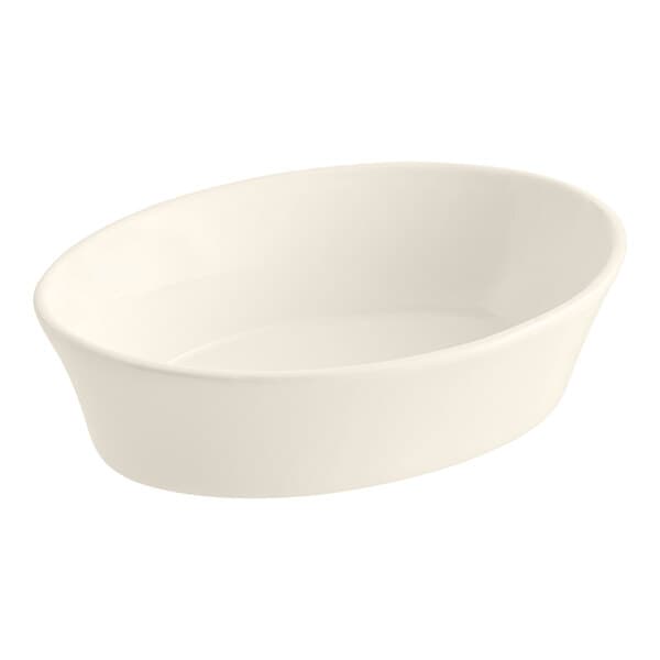 An ivory oval bowl with a curved edge on a white background.