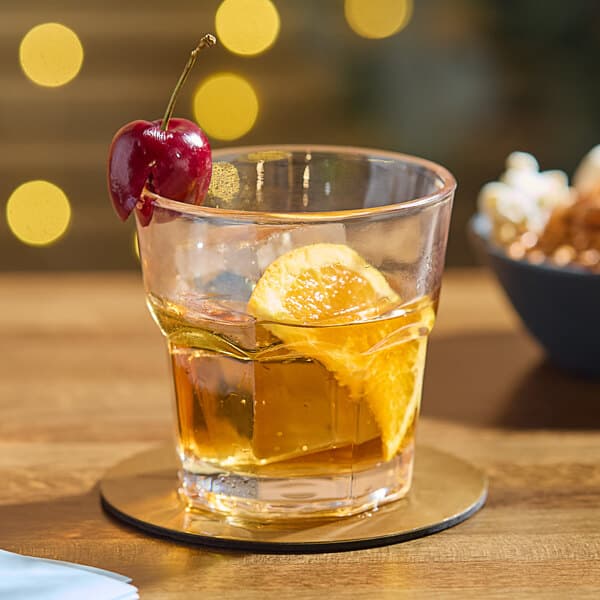 An Acopa Memphis rocks glass with a drink and fruit garnish.