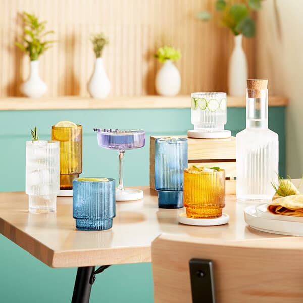 Acopa Lore goblets on a table with drinks.