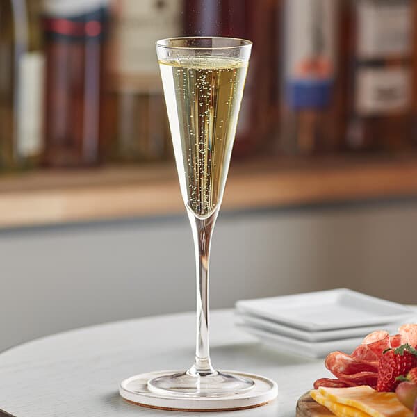 A close-up of a glass of champagne on a table.