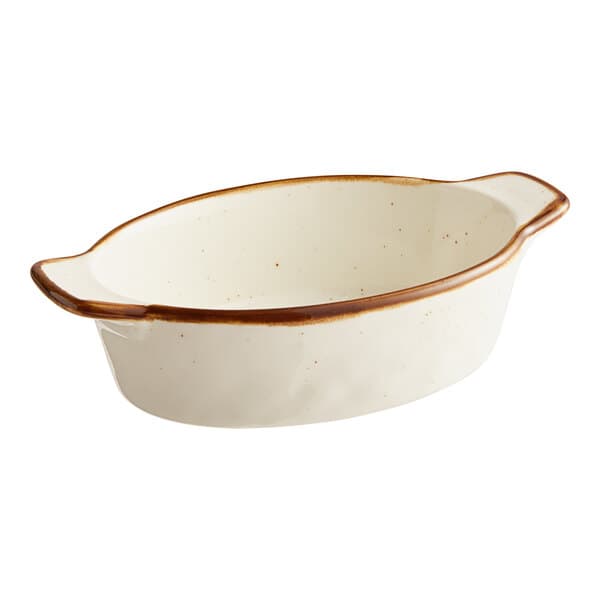 A white porcelain Acopa mini rarebit dish with brown specks.