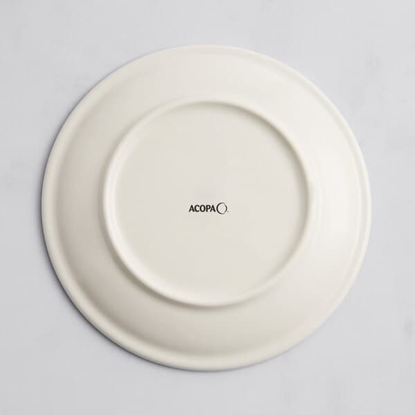 A white Acopa porcelain coupe plate with a circular design in black text.
