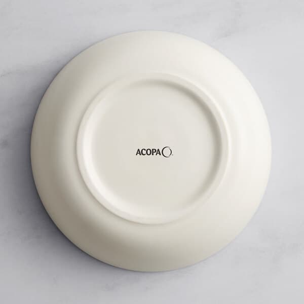 An Acopa Cape beige porcelain bowl on a white surface.