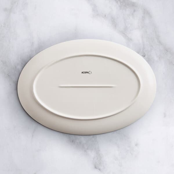 An Acopa Cape gray porcelain oval platter on a marble surface.
