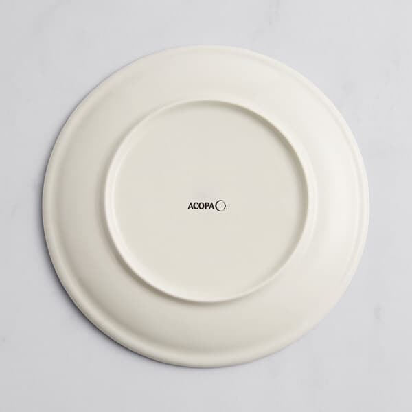 A white Acopa porcelain coupe plate with a circular design in black.