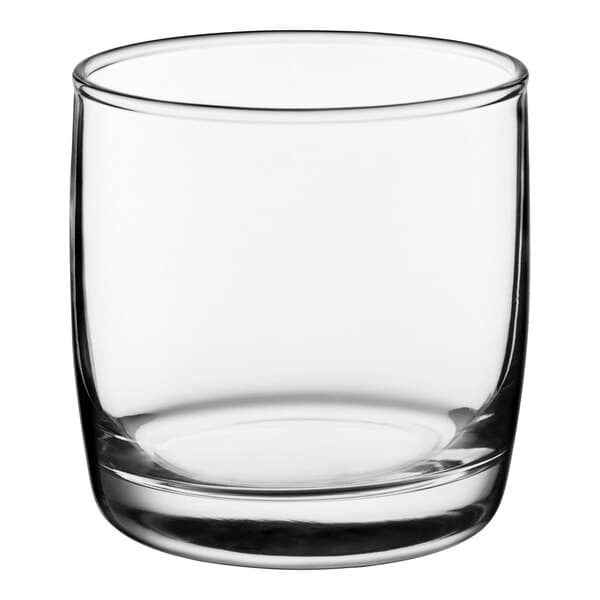 A clear, short, round glass tumbler designed for serving 10 oz. of beverages such as whiskey or cocktails.
